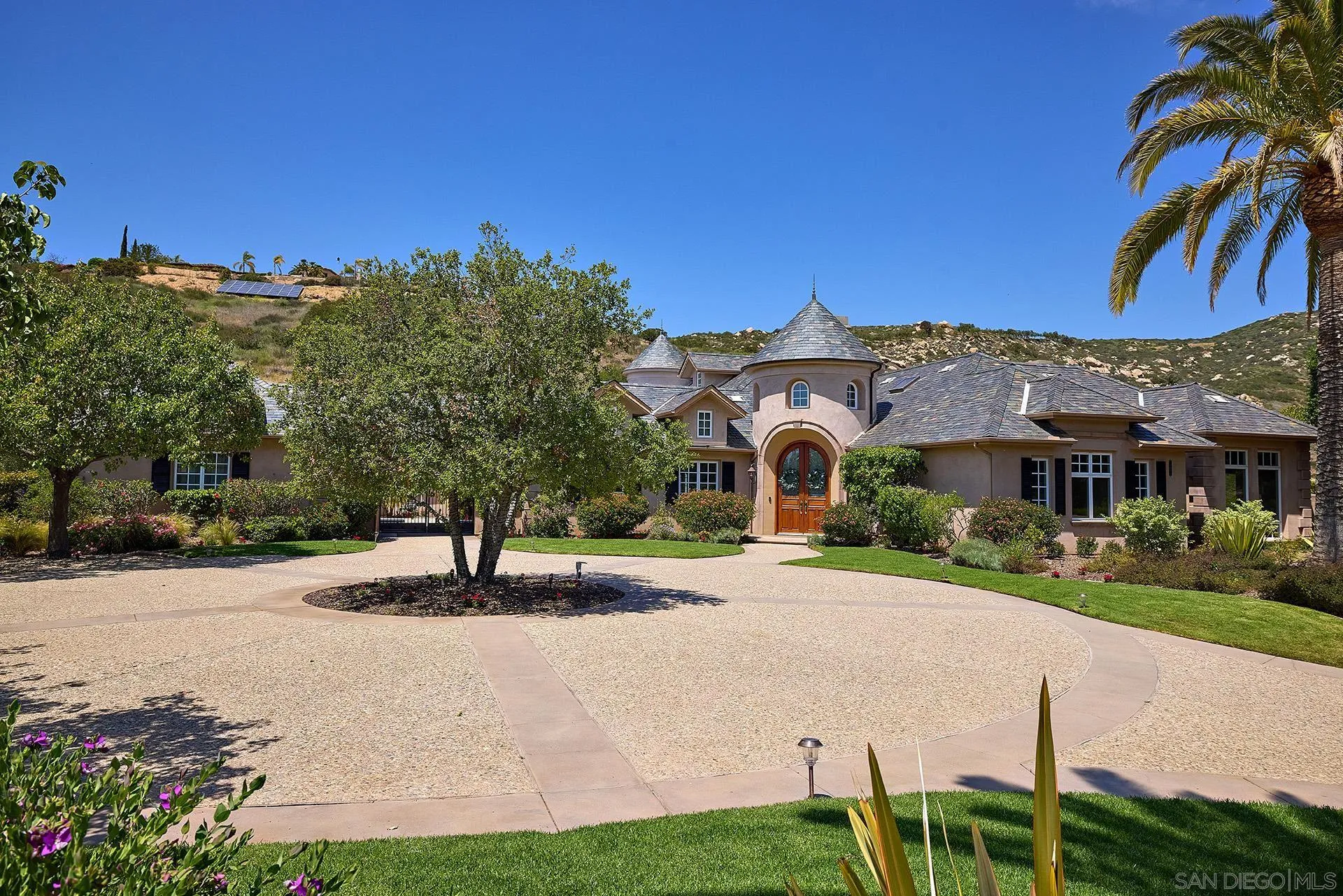 14460 Cheyenne Trail Poway, CA 92064 - Photo 12 of 74 a front view of a house with a yard and potted plants