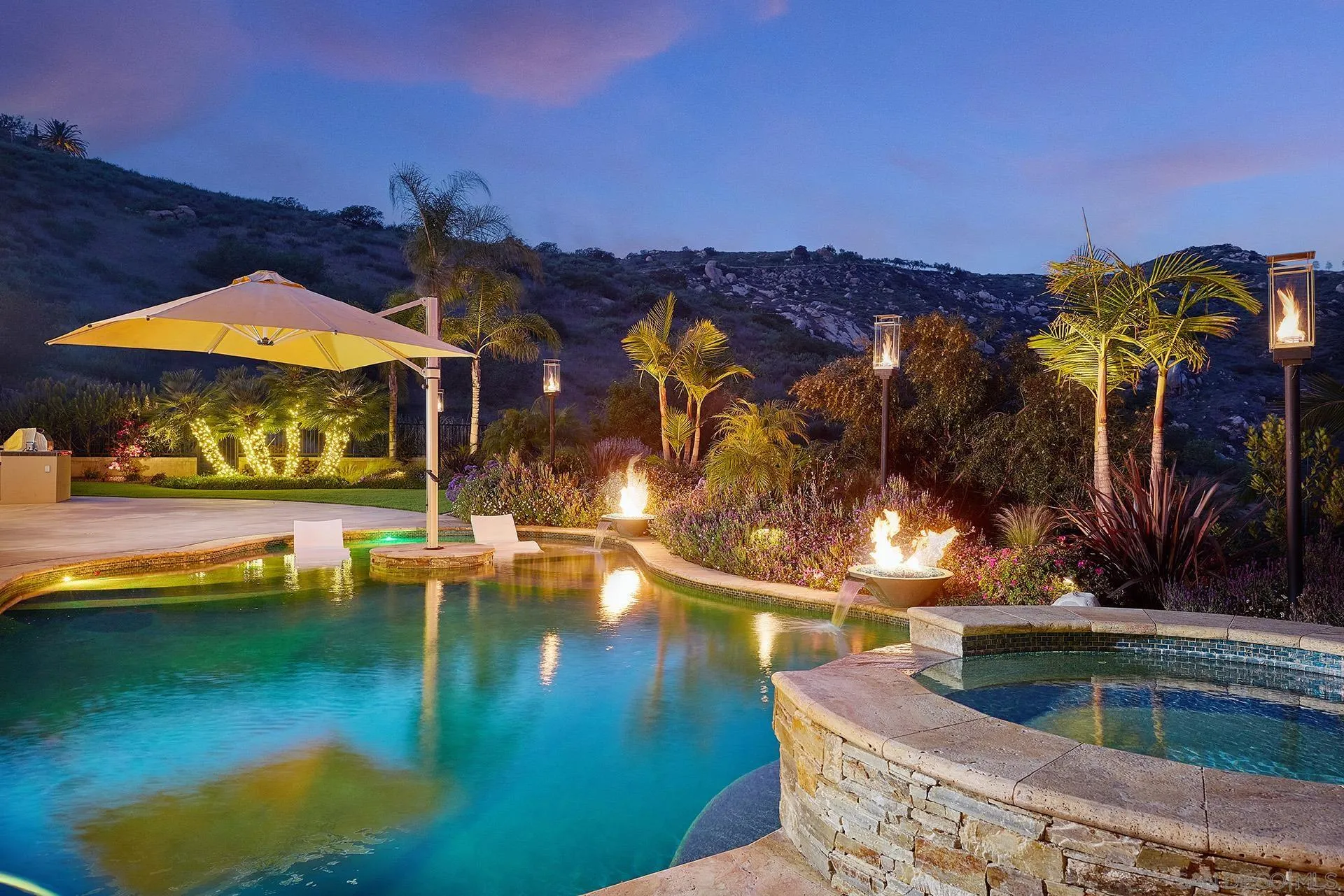 14460 Cheyenne Trail Poway, CA 92064 - Photo 2 of 74 a view of a swimming pool with a lawn chairs under an umbrella
