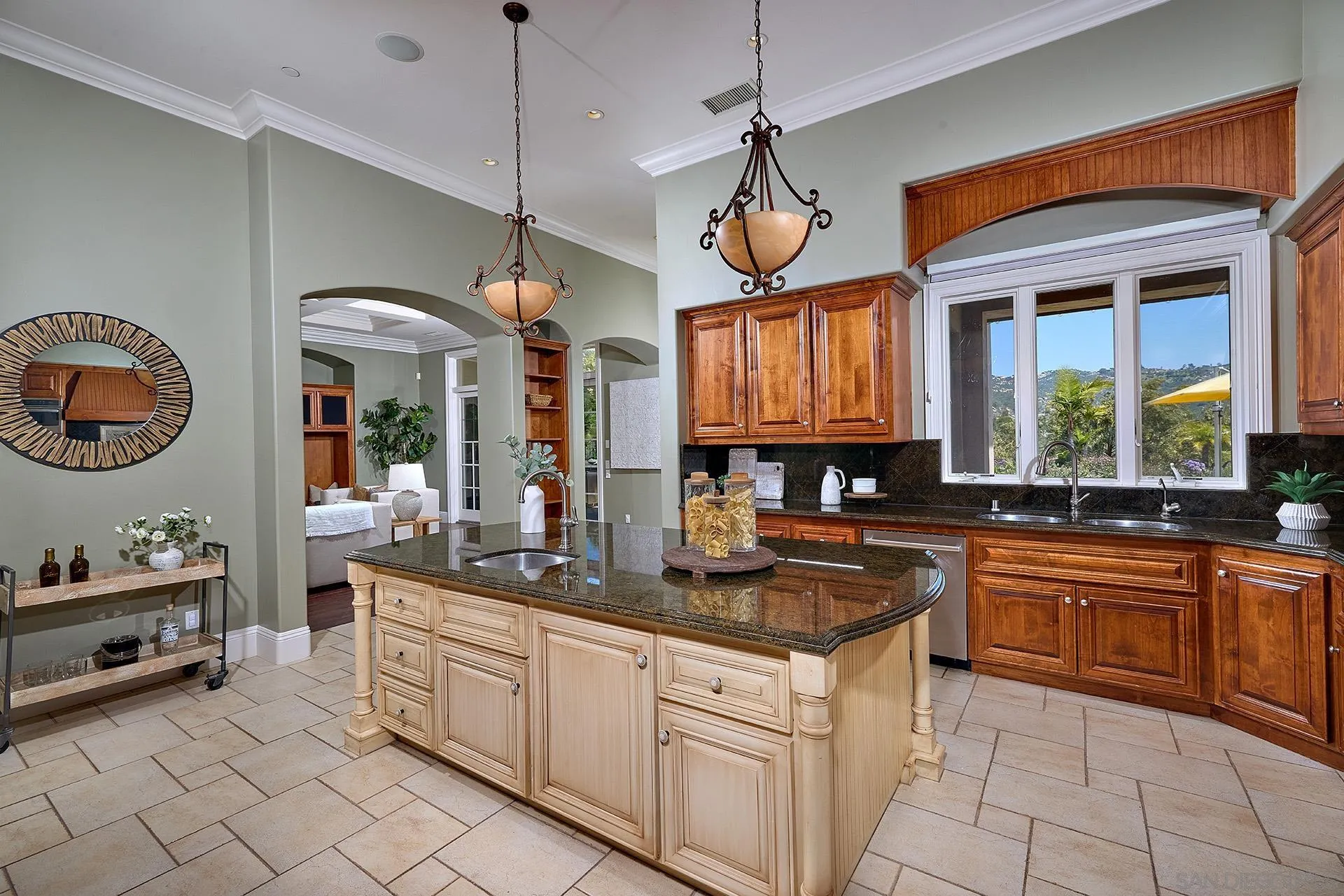 14460 Cheyenne Trail Poway, CA 92064 - Photo 25 of 74 a kitchen with cabinets a stove and a chandelier