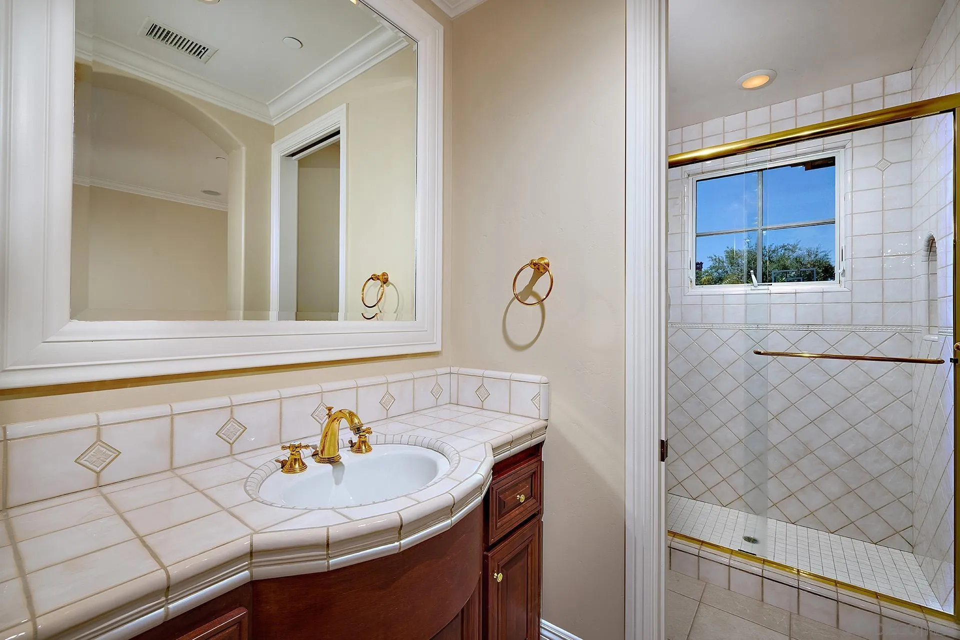 14460 Cheyenne Trail Poway, CA 92064 - Photo 38 of 74 a bathroom with a sink and a mirror