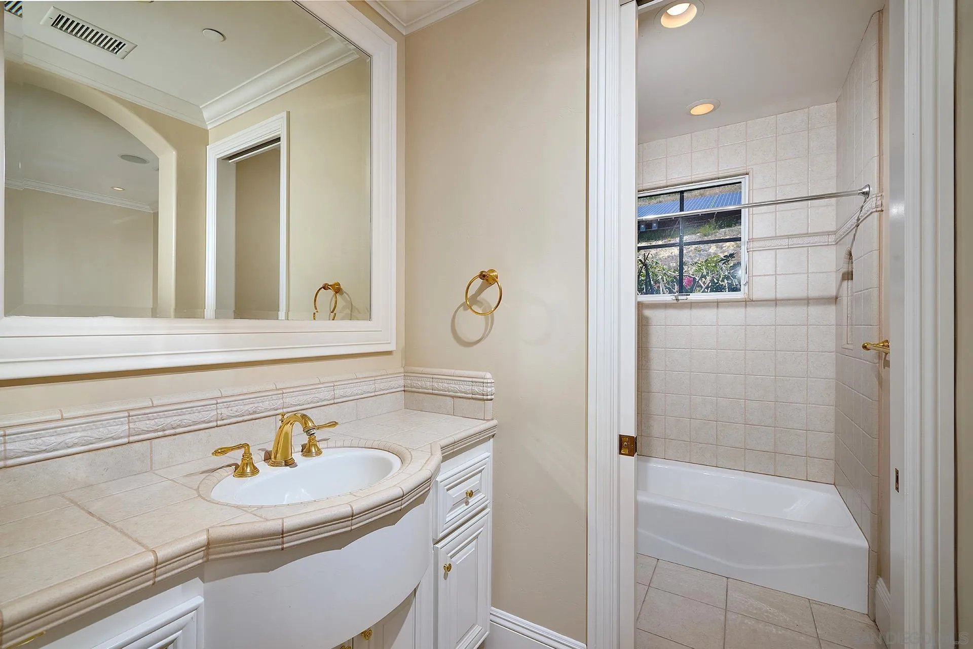 14460 Cheyenne Trail Poway, CA 92064 - Photo 40 of 74 a bathroom with a sink a toilet a shower and a mirror