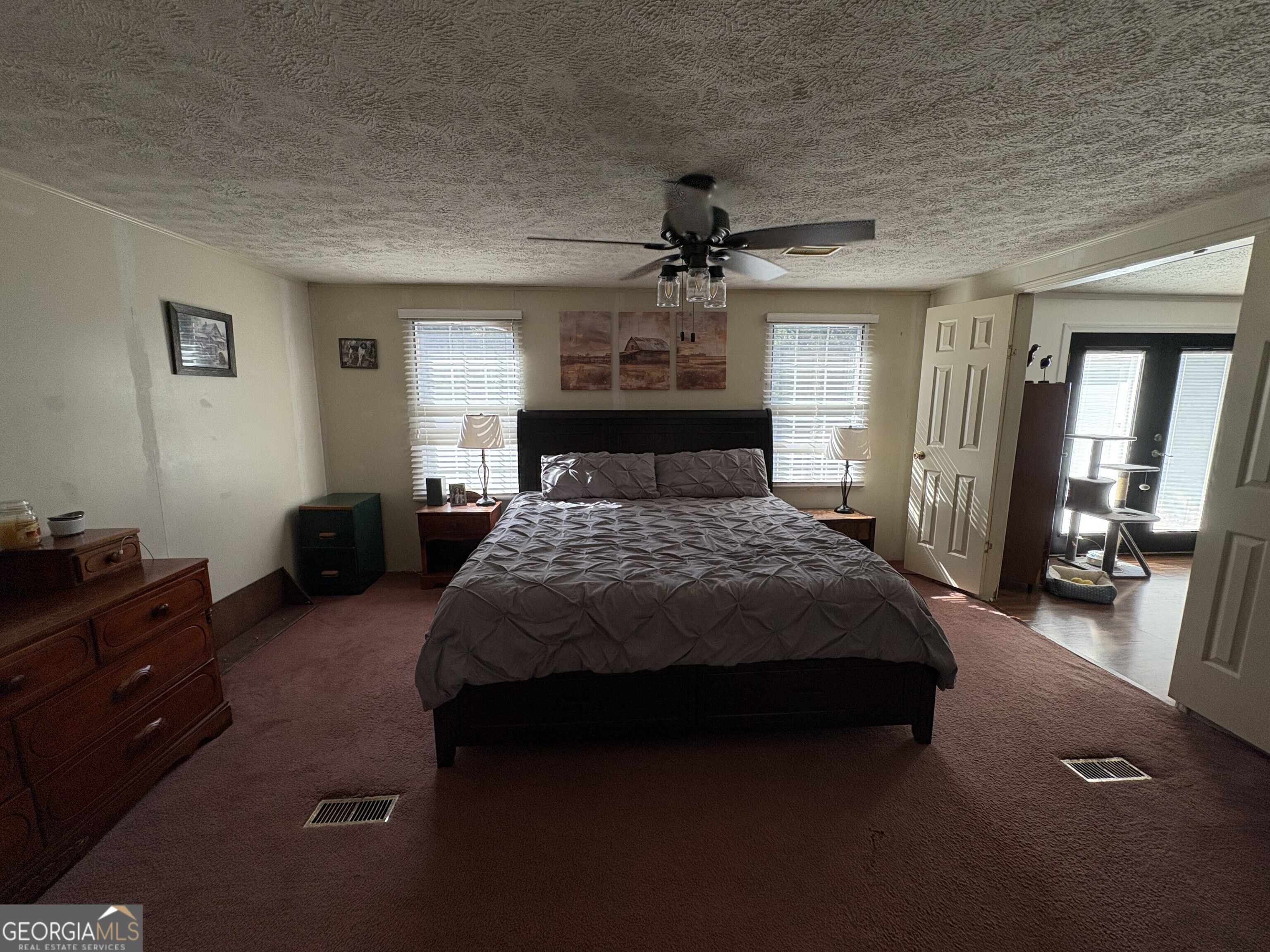 314 Cedar Creek Road Harrison, GA 31035 - Photo 11 of 20 a bedroom with a bed and a mirror on the dresser
