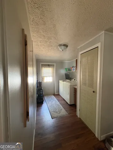 a kitchen with a refrigerator and white cabinets