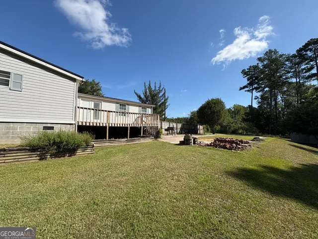 a view of a house with backyard porch and sitting area