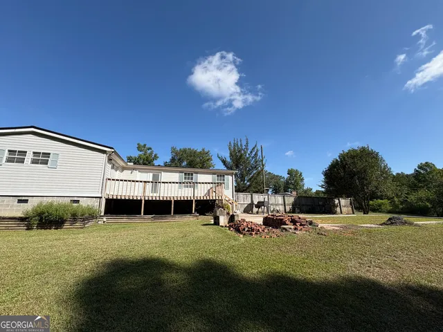 a view of a house with a backyard porch and sitting area