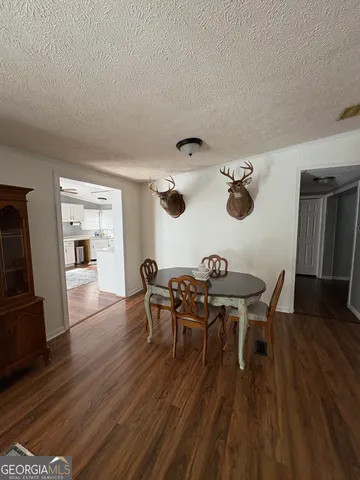 a view of a dining room with furniture and wooden floor