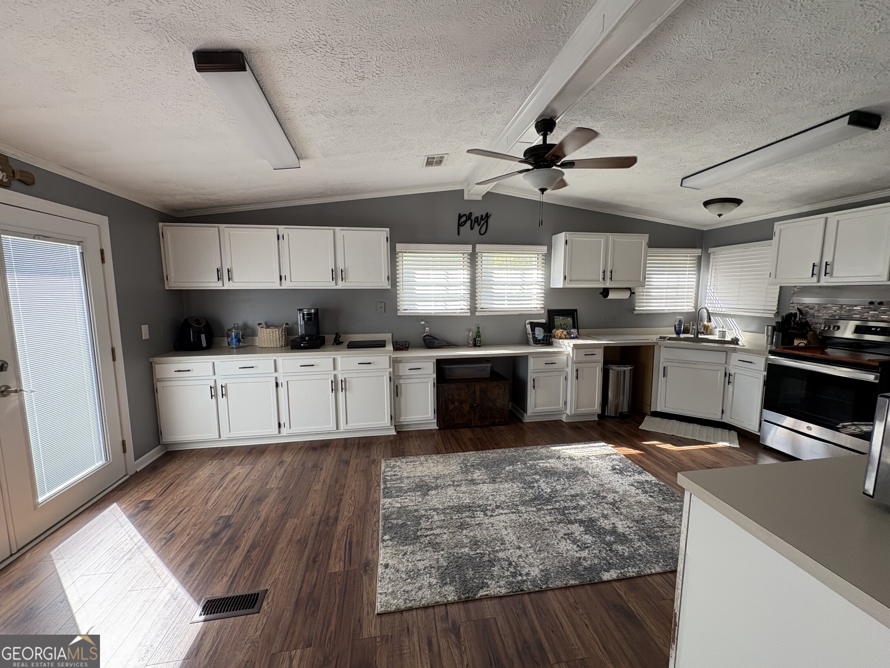 314 Cedar Creek Road Harrison, GA 31035 - Photo 8 of 20 a kitchen with stainless steel appliances kitchen island granite countertop a stove sink and cabinets