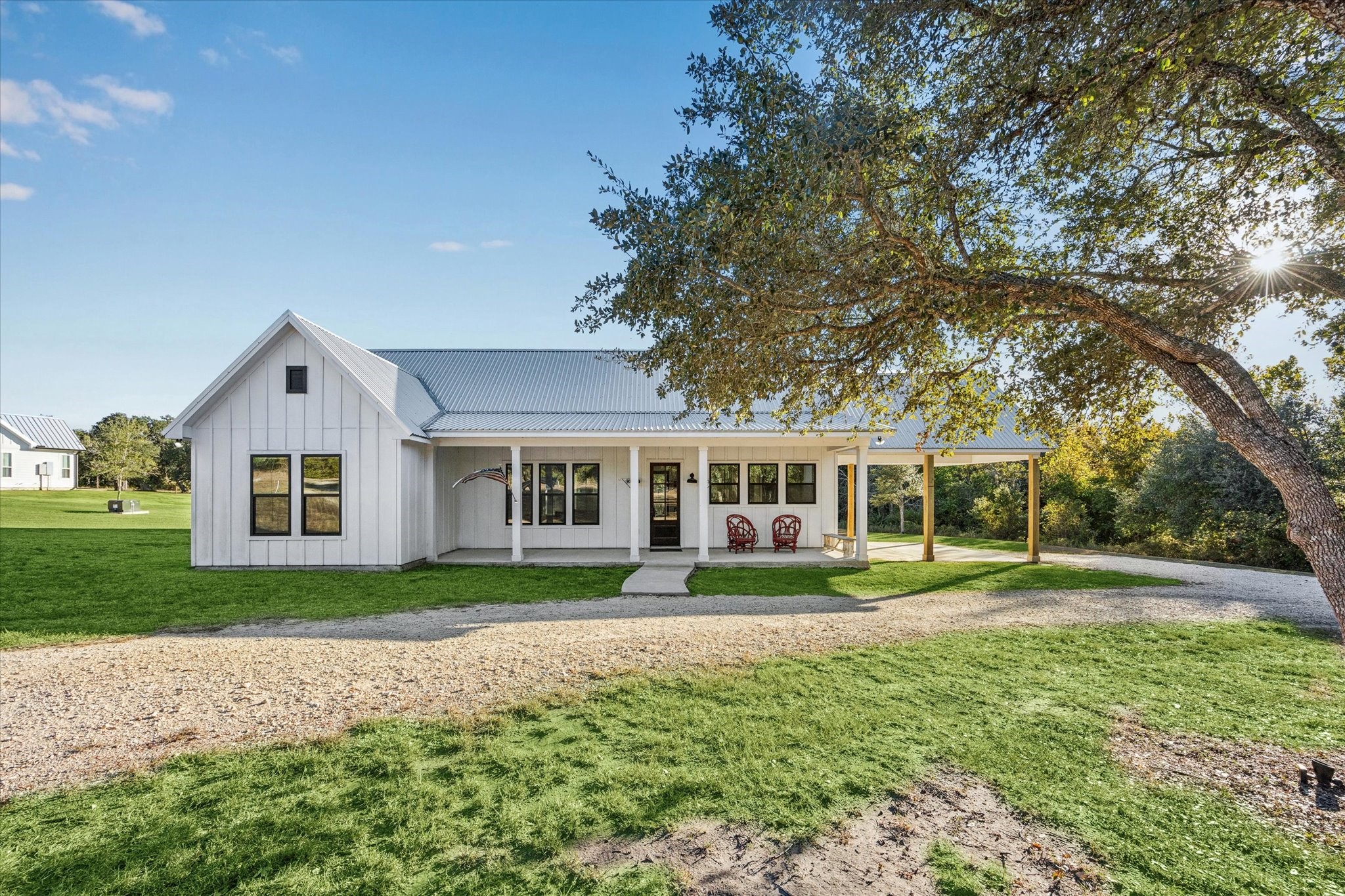 a front view of a house with a yard and trees
