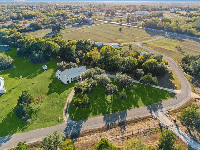 an aerial view of residential houses with outdoor space and river