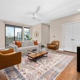 a living room with furniture rug and window