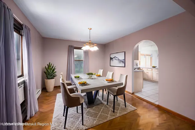 a view of a dining room with furniture and a chandelier