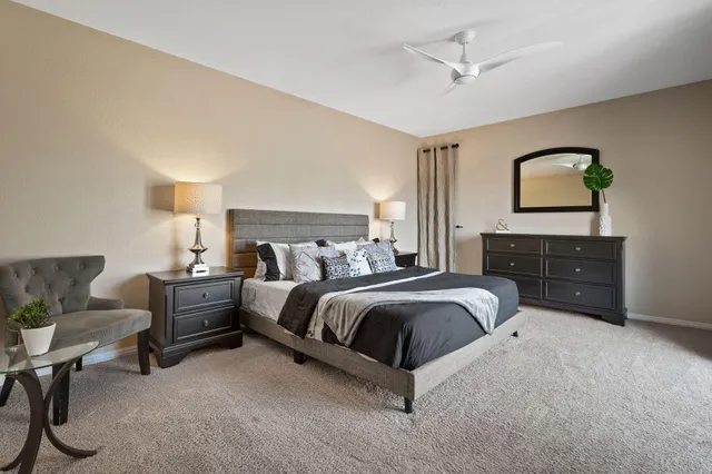 a spacious bedroom with a bed and window