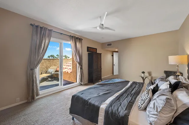 a bedroom with a large bed and a large window