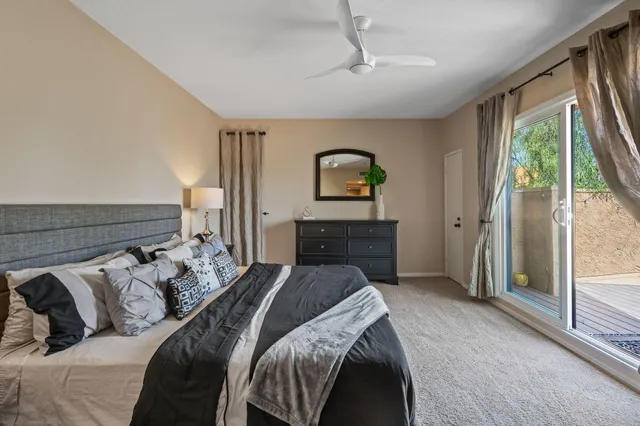 a bed sitting in a bedroom next to a window