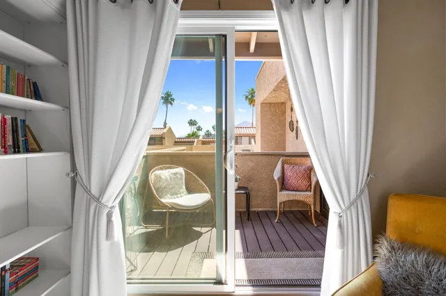 a living room with furniture and a lamp