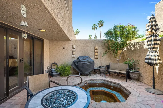 a view of backyard with outdoor seating and plants