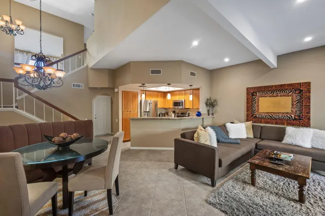 a living room with furniture and a chandelier