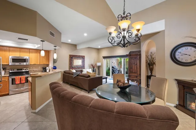 a living room with fireplace furniture and a large window