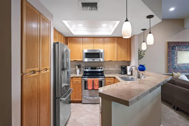a kitchen with sink refrigerator and microwave