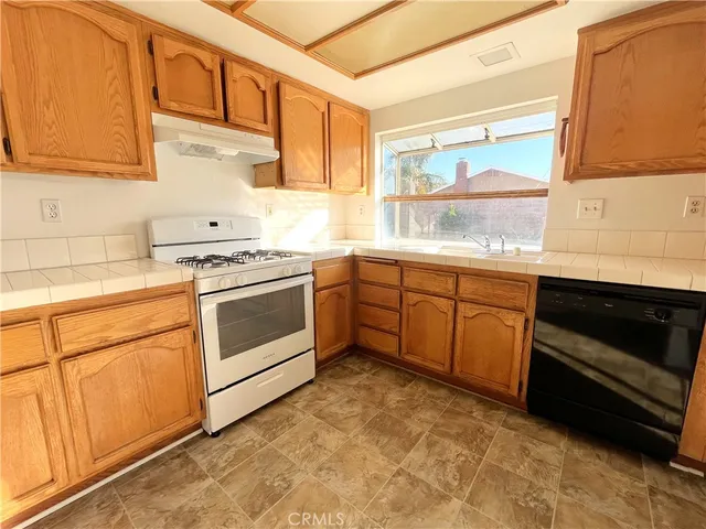 a kitchen with a stove a sink and a microwave