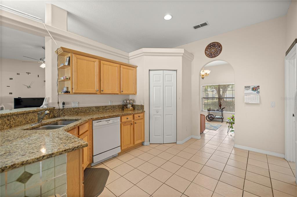 4555 Northwest 6th Circle Ocala, FL 34475 - Photo 13 of 38 a kitchen with granite countertop a sink and a refrigerator