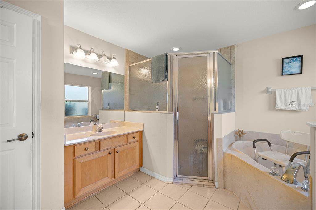 4555 Northwest 6th Circle Ocala, FL 34475 - Photo 22 of 38 a bathroom with a granite countertop sink mirror and bathtub