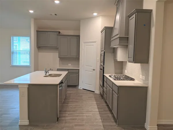 a kitchen with a sink stove and refrigerator