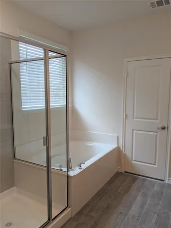 a bathroom with a bathtub and a shower