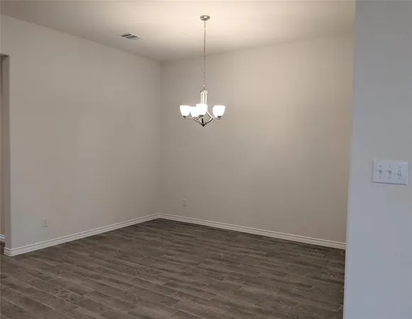 a view of a room with wooden floor and fan