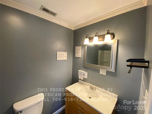 a bathroom with a sink toilet and mirror