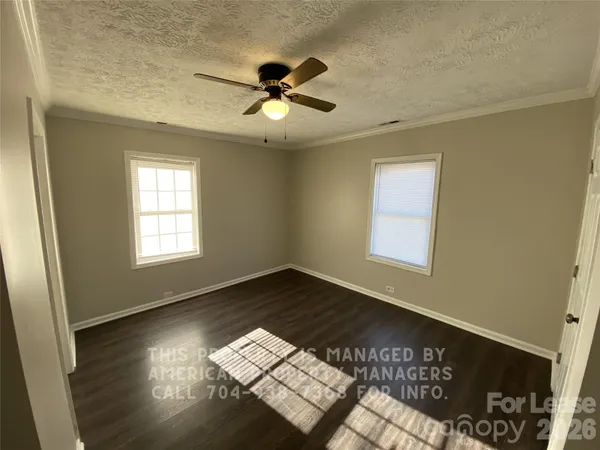 a view of wooden floor and windows in a room