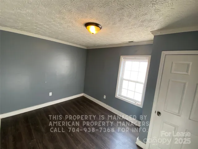 a view of an empty room and wooden floor