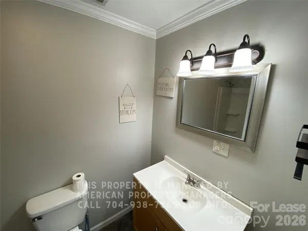 a bathroom with a sink toilet and mirror