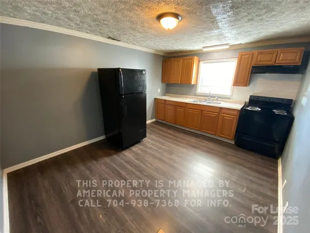 a kitchen with granite countertop stainless steel appliances and counter space