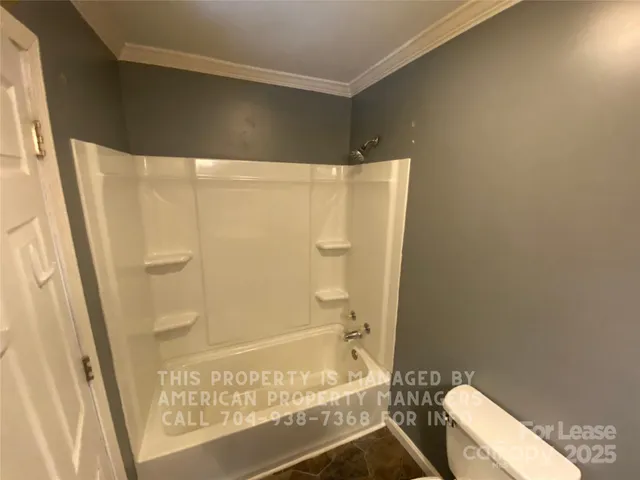 a bathroom with a shower and a toilet