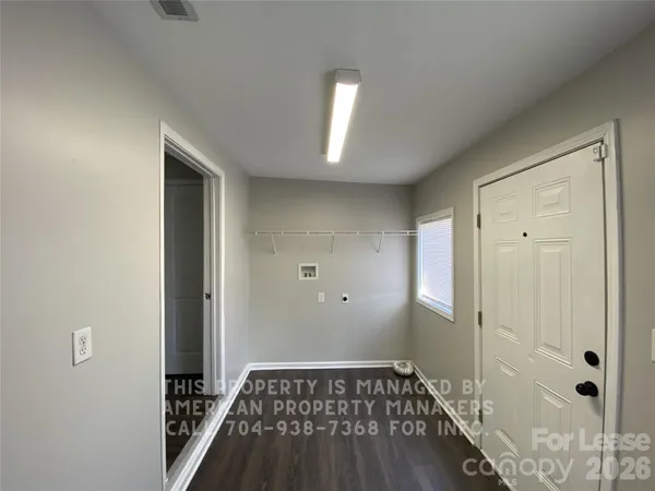 a view of a livingroom with wooden floor and a rug