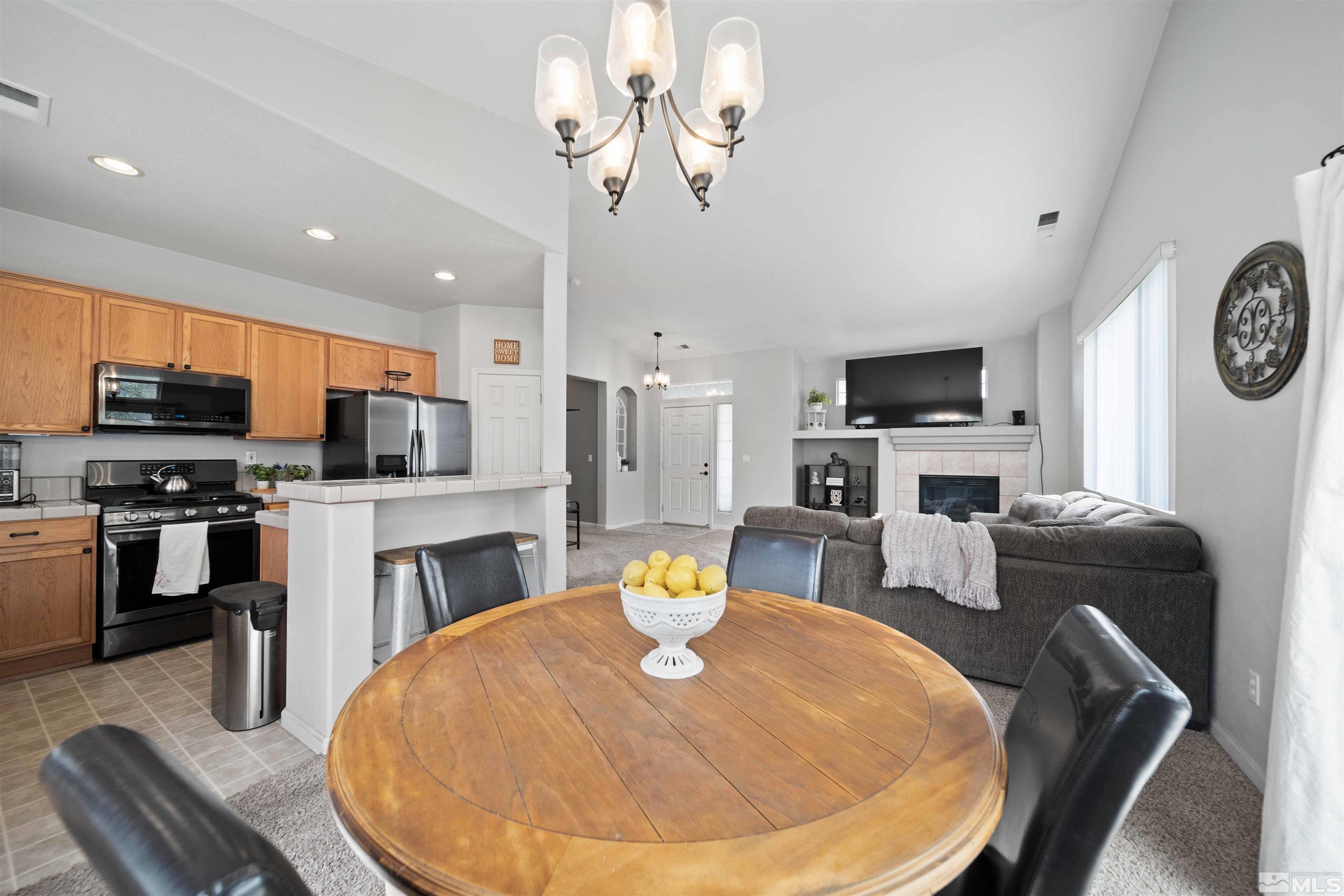 10599 Iron Point Circle Reno, NV 89521 - Photo 14 of 39 a living room with fireplace furniture and a flat screen tv