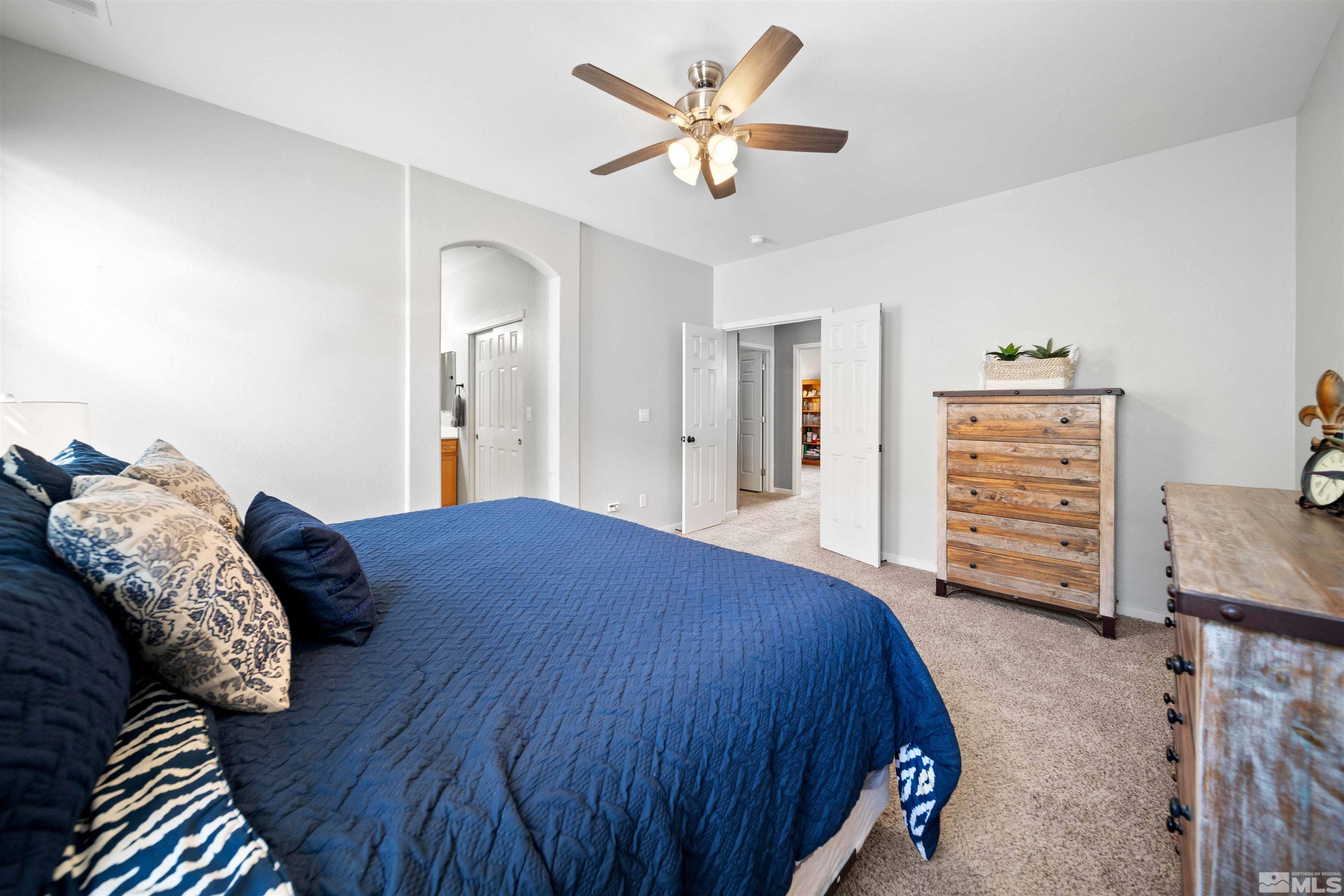 10599 Iron Point Circle Reno, NV 89521 - Photo 18 of 39 a bedroom with a bed and a dresser