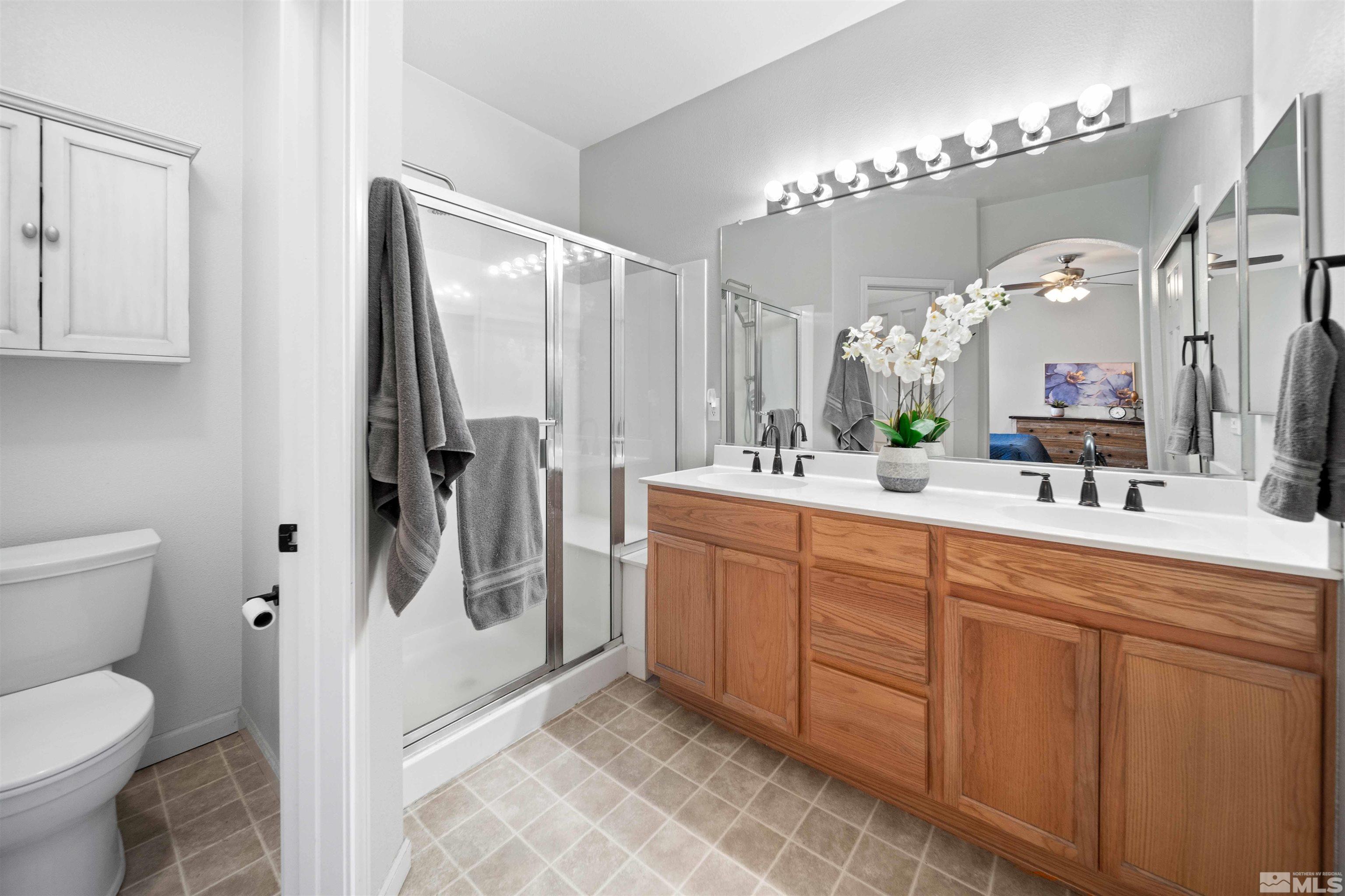 10599 Iron Point Circle Reno, NV 89521 - Photo 19 of 39 a spacious bathroom with a toilet sink and mirror