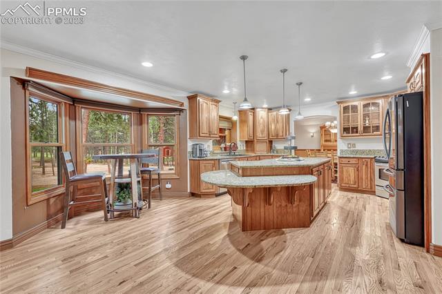 10745 Hungate Road Colorado Springs, CO 80908 - Photo 11 of 46 Large eat-in kitchen with hardwood floors, a bay of windows...