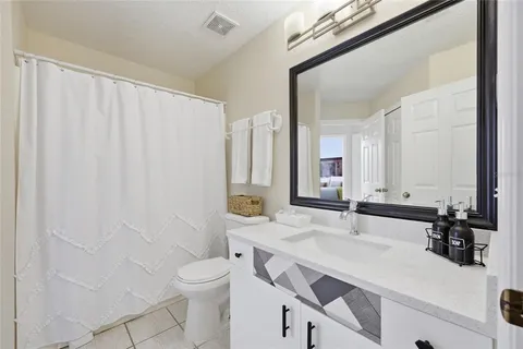 a bathroom with a toilet a sink and a mirror