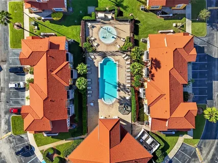 a living room with furniture kitchen view and a flat screen tv
