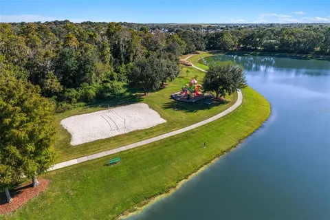 an aerial view of a house with a yard basket ball court and outdoor seating