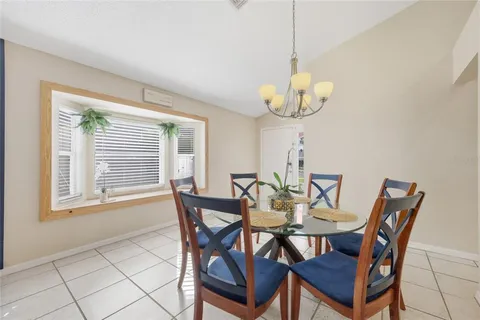 a view of a dining room with furniture and a chandelier