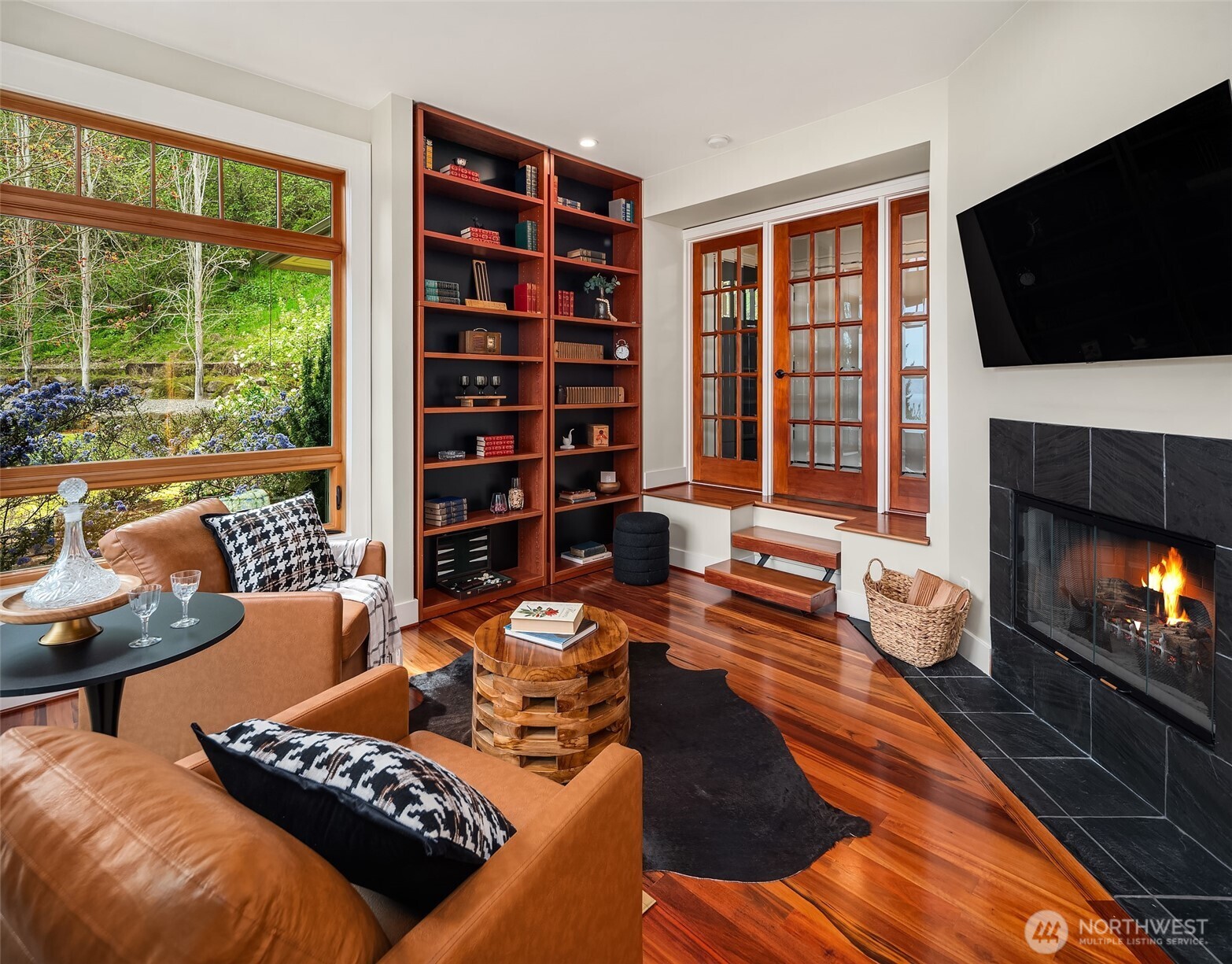 8302 Southwest Dilworth Road Vashon, WA 98070 - Photo 11 of 40 a living room with furniture a flat screen tv and a fireplace