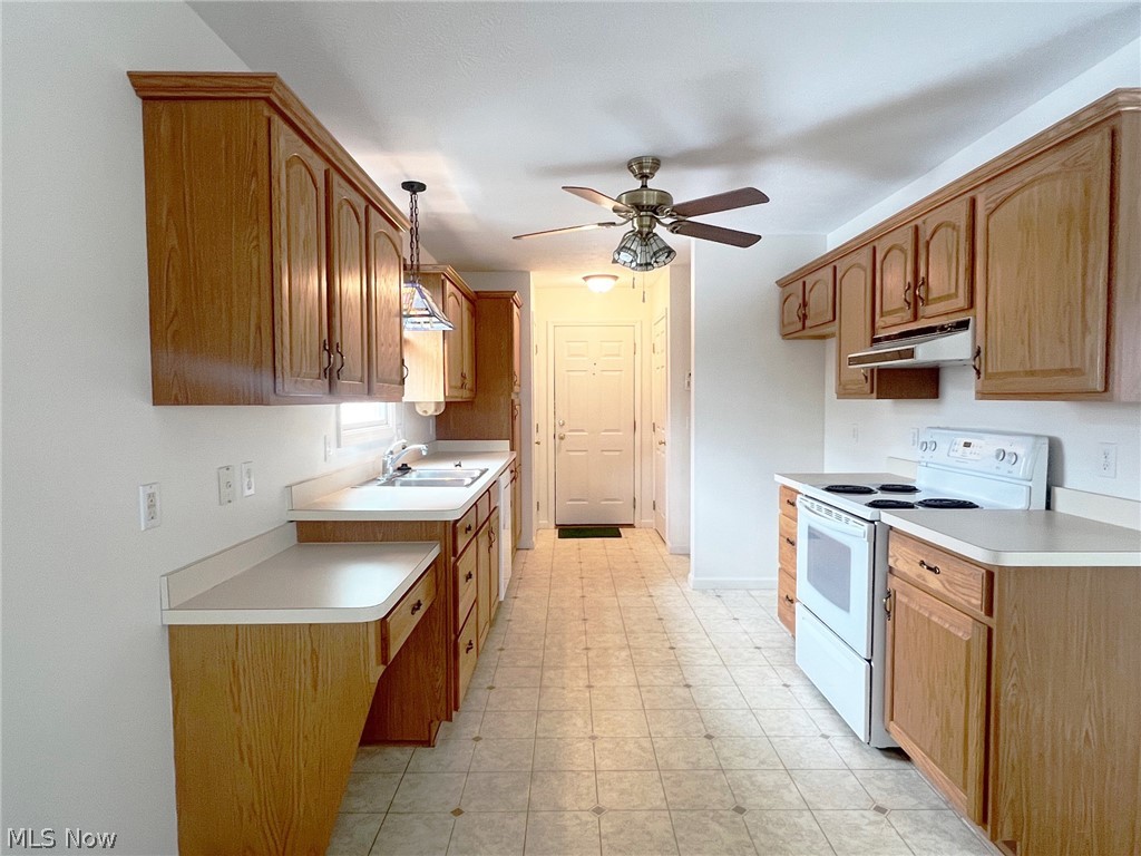 5203 Ridgeland Street Lorain, OH 44055 - Photo 12 of 39 Kitchen featuring light tile flooring, ceiling fan, sink, pendant lighting, and white range with electric cooktop