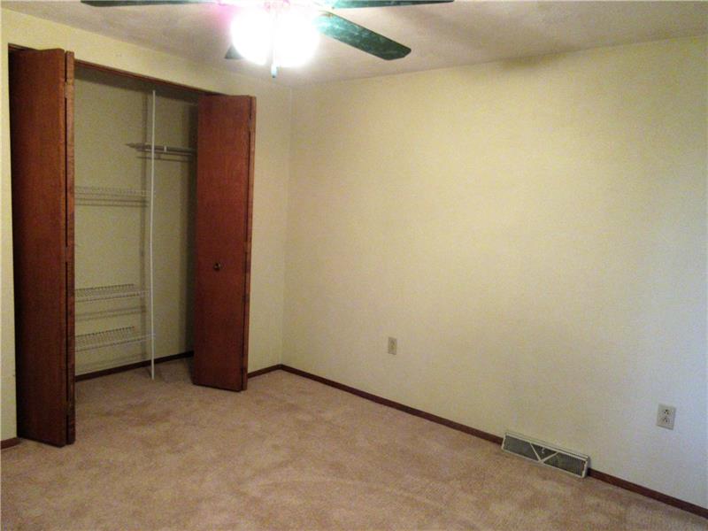 242 Boyd Road Freeport, PA 16229 - Photo 14 of 25 Bedroom two has a double closet with a closet organizer and lighted ceiling fan.