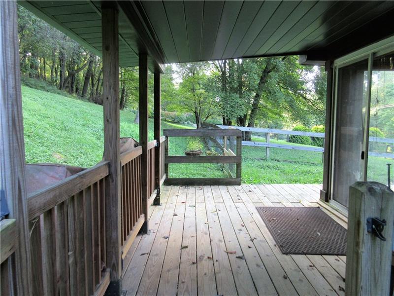 242 Boyd Road Freeport, PA 16229 - Photo 7 of 25 The glass siding doors in the four season room lead to this 15x8' covered back deck and fenced in yard area.