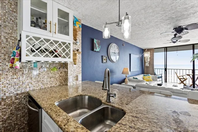 a kitchen with a sink and a stove top oven
