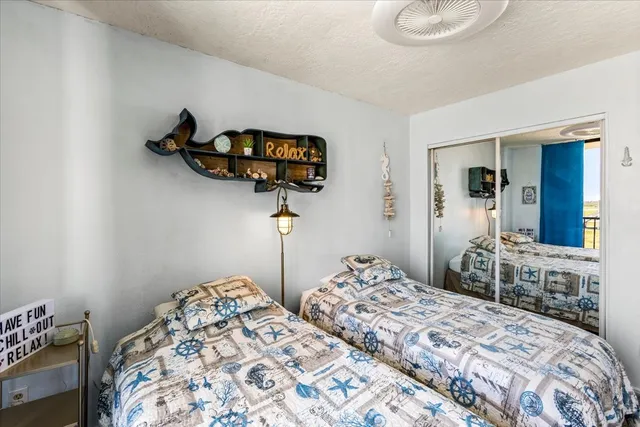 a bedroom with bed and a chandelier